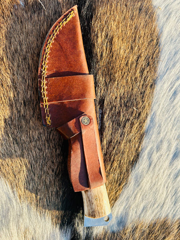 Premium Damascus Gut Hook Knife for Hunting inside protective leather sheath